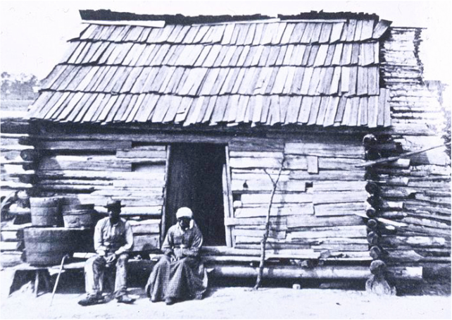 Slaves Sitting in Front of Their Cabin